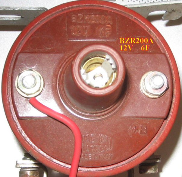 The solid core red covered wire appears to be tin plated silver. A cZ flat washer is used at either connection (coil/resistor) then topped with a cZ split lock at coil or cZ ext star at resistor, then the cZ nut.     cZ=clear zinc, yZ = chromated yellow zinc<br />Solid red wire ends are appropriately curled into nice loops at either end prior to installation.